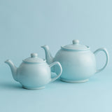 Blue P & K PRICE & KENSINGTON teapot with two matching teacups, ceramic tea set on a white background.