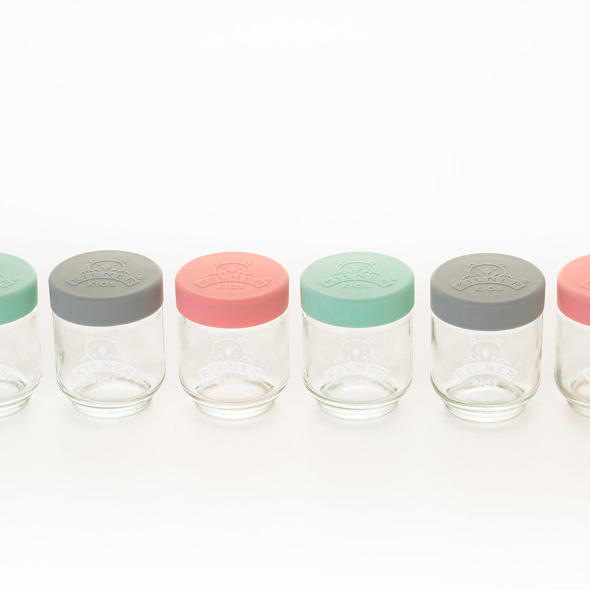 Colorful KILNER baby jars in clear glass with vibrant patterns, perfect for storing baby food or snacks.