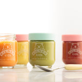 KILNER baby glass jars in clear and colorful designs, suitable for storing baby food or snacks, with a secure lid.