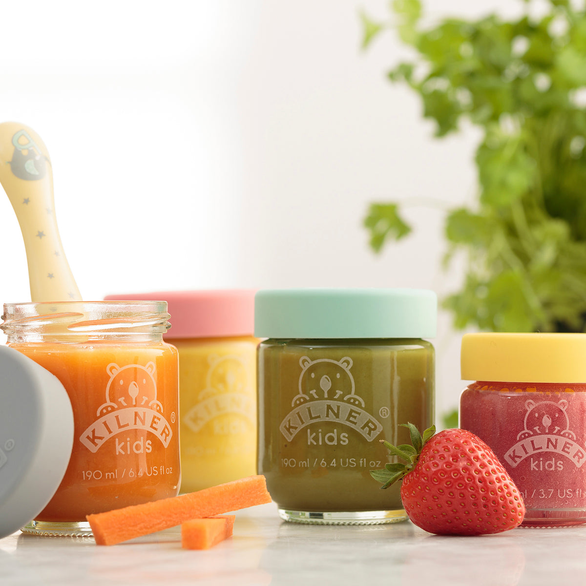 Colorful KILNER baby glasses in clear and bright colors, designed for storing baby food or snacks.