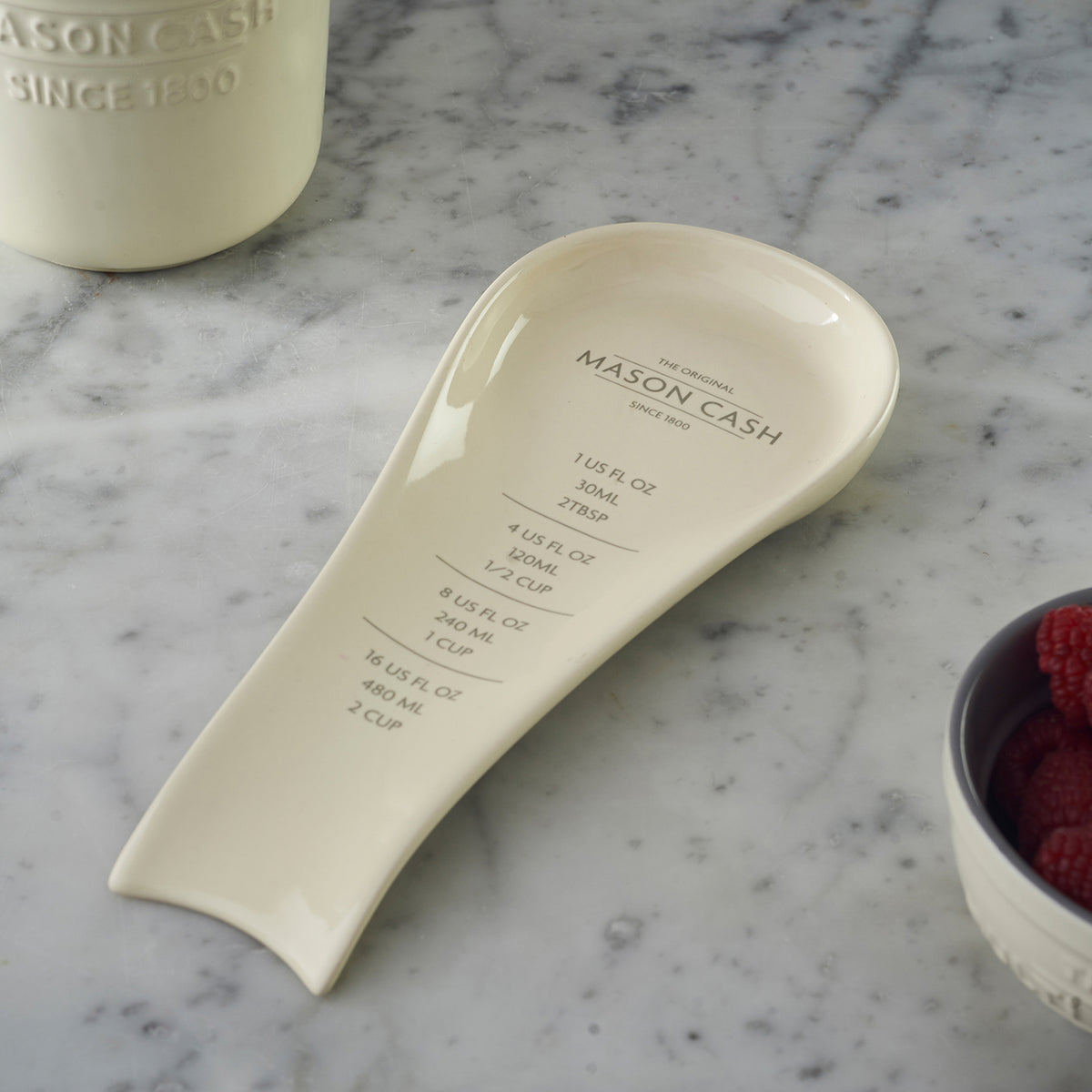 White Mason Cash spoon rest, 25 cm long, with a simple, functional design for holding cooking utensils.