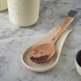 White Mason Cash spoon rest, 25 cm long, with a simple rectangular design and raised edges for holding kitchen utensils.