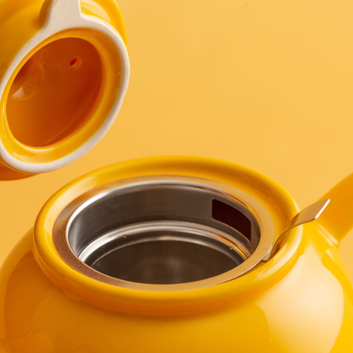 P & K PRICE & KENSINGTON yellow teapot with a smooth, rounded design and a matching lid, made of ceramic material.