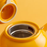 P & K PRICE & KENSINGTON yellow teapot with a smooth, rounded design and a matching lid, made of ceramic material.