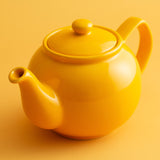 P & K PRICE & KENSINGTON yellow teapot with a glossy finish, featuring a rounded body and curved spout on a neutral background.
