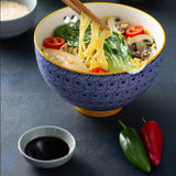 Blue TYPHOON Asian noodle bowl with chopsticks, round shape, perfect for serving noodles and Asian cuisine.