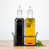 Clear glass KILNER oil and vinegar bottles with stoppers, ideal for storing and pouring oils or vinegars in the kitchen.