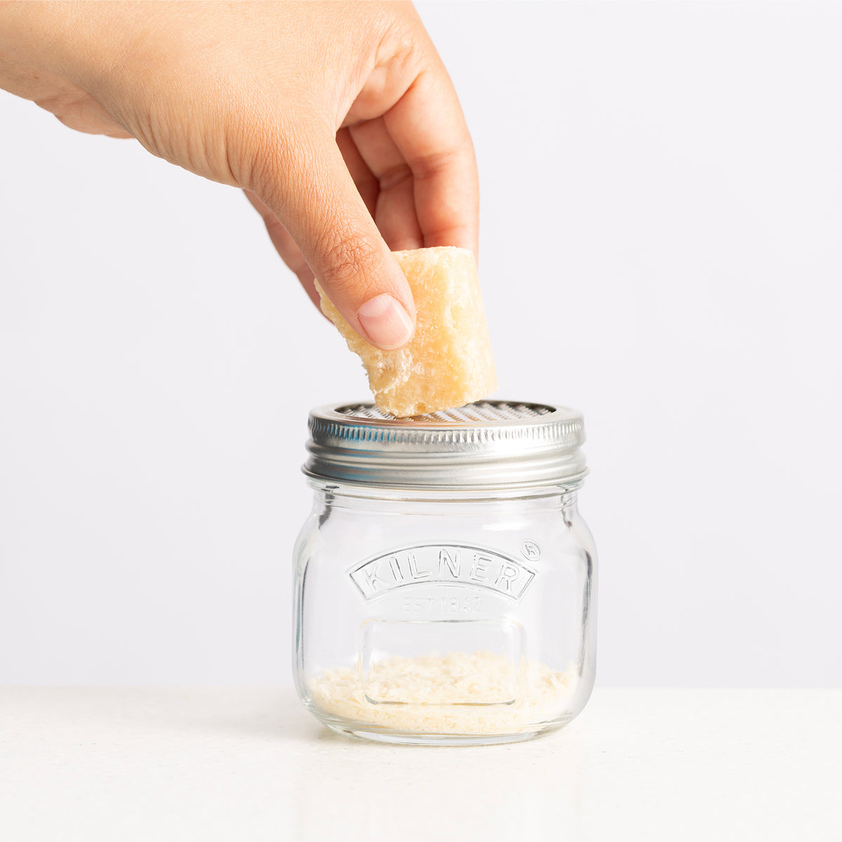 KILNER fine grater with glass container, clear plastic body, 250 ml capacity, suitable for grating spices and zest.
