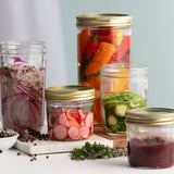 KILNER clear wide-neck canning jar with metal screw lid, ideal for preserving fruits and vegetables.