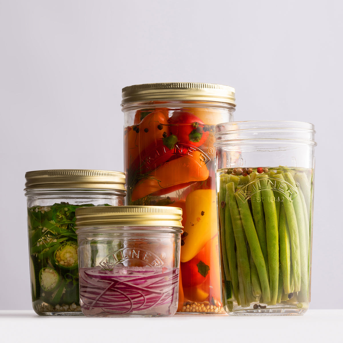 Clear Kilner wide-mouth canning jar with glass lid, showcasing its transparent design and sturdy construction for preserving food.