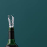 Clear VINERS wine aerator pouring wine into a glass, showcasing its sleek design and transparent construction.