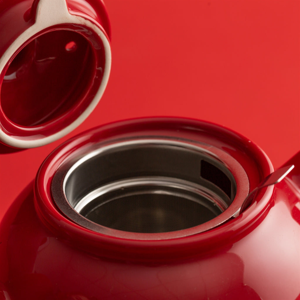 Red P & K teapot with built-in tea infuser, designed for six cups, perfect for brewing loose leaf tea.