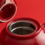 Red P & K teapot with built-in tea infuser, designed for six cups, perfect for brewing loose leaf tea.