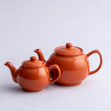 Price & Kensington Teekanne teapot with orange design, ceramic body, and lid, showcasing a vibrant orange pattern on white ceramic.