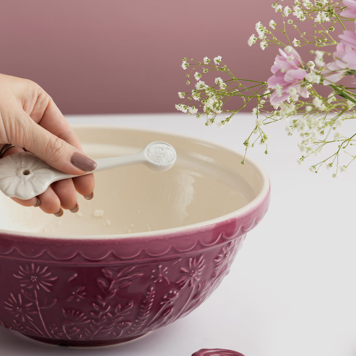 Transparent Mason Cash mixing bowl with floral meadow design, ideal for baking and food preparation.