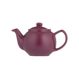 Teekanne P & K mint plum tea in a teapot, with fresh mint leaves and plum flavor, on a cozy wooden table.