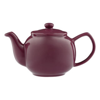 Teekanne PFLAUME mint tea in a teapot with fresh mint leaves, branded P & K, on a white background.
