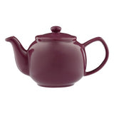 Teekanne PFLAUME mint tea in a teapot with fresh mint leaves, branded P & K, on a white background.