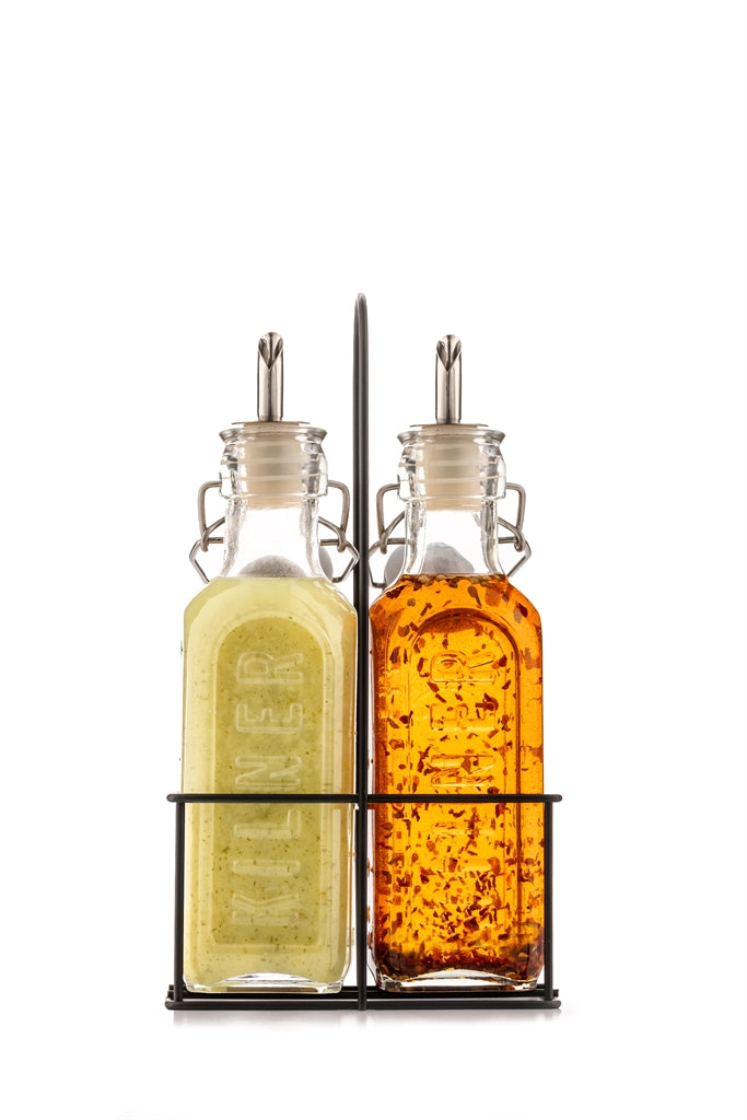 Clear KILNER oil and vinegar bottles with glass stoppers, designed for kitchen use and elegant condiment storage.