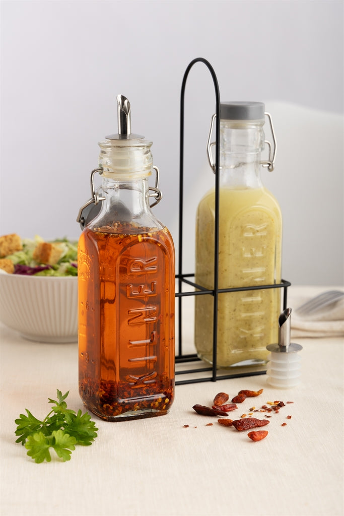 Clear Kilner oil and vinegar bottles with glass stoppers on a white background, showcasing their elegant, transparent design.