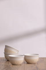 Set of four beige Mason Cash Rustic Charm bowls with a rustic, textured finish for kitchen or serving use.