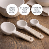 Set of three beige Mason Cash rustic charm measuring spoons, with long handles and engraved size markings.