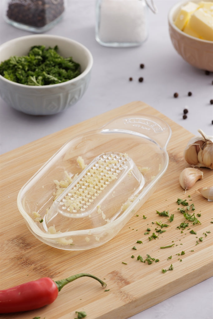KILNER glass kitchen grater with 20 cm stainless steel surface and clear glass container for efficient food grating.
