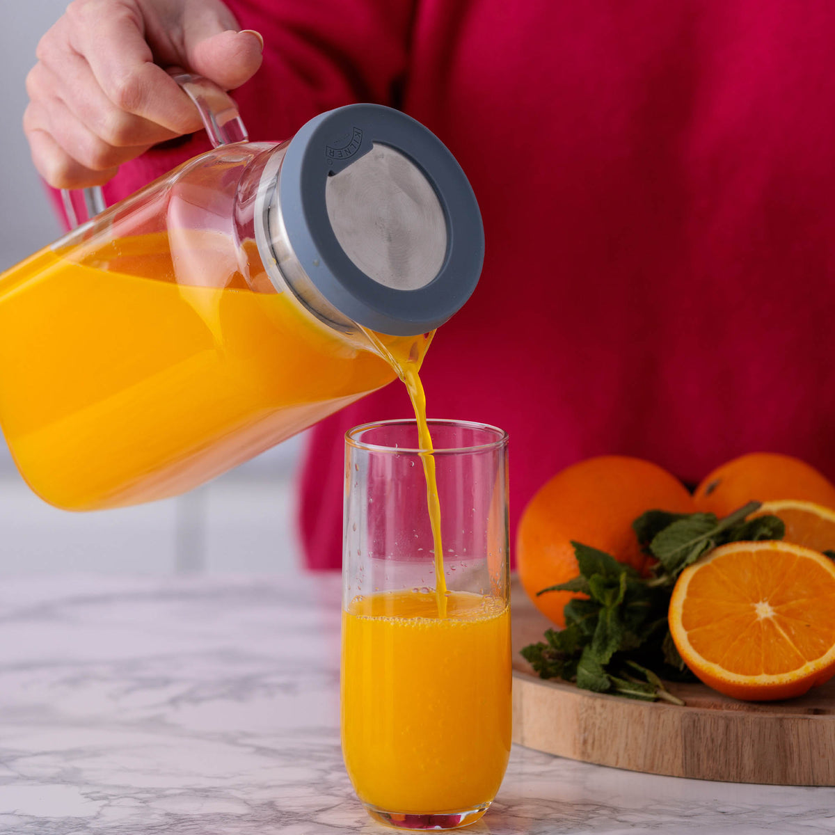 Clear 1.2L KILNER glass jug with handle, ideal for serving beverages or storing liquids in a kitchen or dining setting.