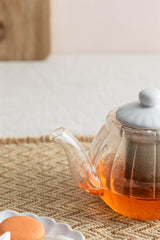 Clear glass teapot from PRICE & KENSINGTON LUXE series by P & K, featuring a sleek design and a stainless steel lid.