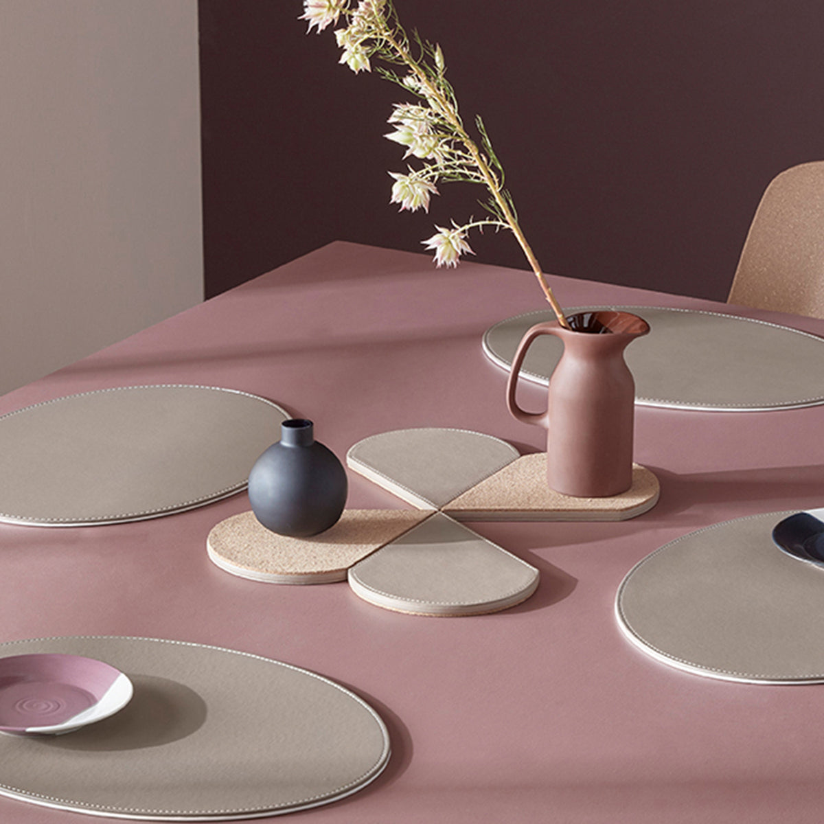 FREEFORM DUO oval placemat set in taupe and white, featuring two elegant, oval-shaped placemats for table setting decor.