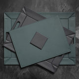FREEFORM DUO coaster set with four round cork and silicone drink coasters on a wooden surface.