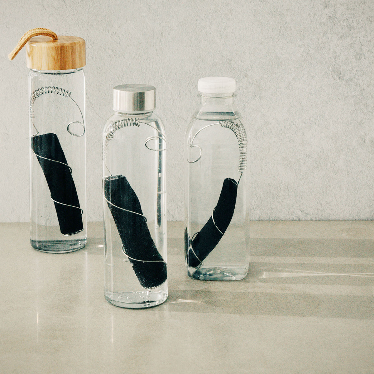 Black+Blum CARACOL charcoal filter in black, showing the cylindrical design and mesh surface for effective air purification.