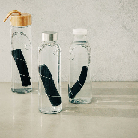 Black+Blum CARACOL charcoal filter in black, showing the cylindrical design and mesh surface for effective air purification.