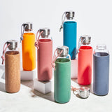 BLACK+BLUM TO-GO GLAS water bottle in ocean blue, 600ml, with a sleek glass design and black silicone sleeve for portability.