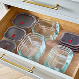 Set of four BLACK+BLUM multifunctional glass storage tins with clear lids, ideal for kitchen organization and food storage.