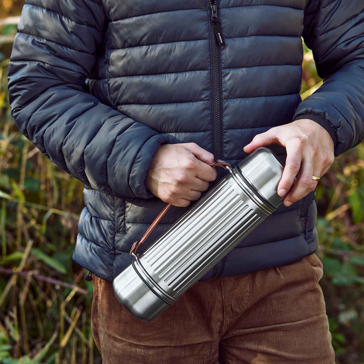 BLACK+BLUM DUO stainless steel insulated flask, 1.4L, with a sleek design and secure lid for hot and cold beverages.