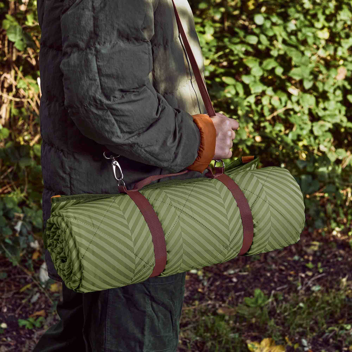 BLACK+BLUM green picnic blanket, 2 x 1.4 meters, outdoor blanket for picnics and gatherings, shown spread out on grass.