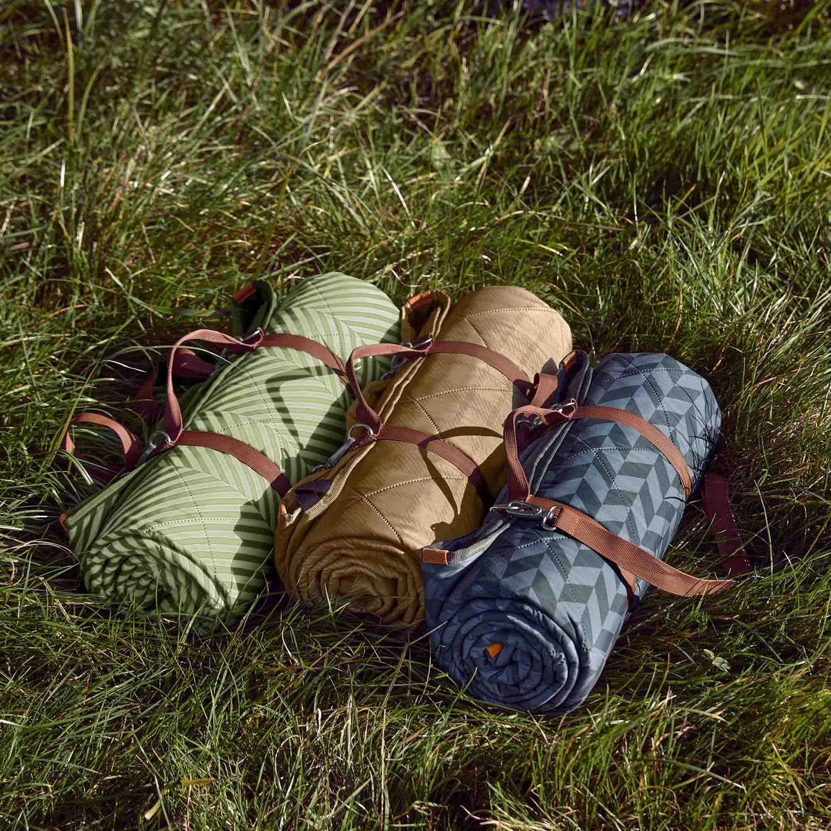 GREEN BLACK+BLUM picnic blanket with 2x1.4m size, outdoor fabric, spread on grassy surface for outdoor activities.