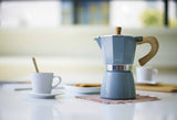 Blue GNALI & ZANI Venezia espresso maker with stainless steel body and ergonomic handle, designed for stovetop brewing.