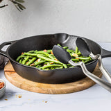 DREAMFARM black kitchen tongs, CLONGS style, stainless steel kitchen utensil for grilling and cooking, close-up image.