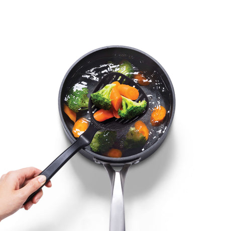 Black LESSTRAIN ladle by DREAMFARM, a kitchen tool with a deep bowl and handle for serving liquids and soups.