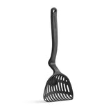 Black kitchen ladle from DREAMFARM Lestrain line, showing a close-up of the sturdy handle and deep bowl for pouring and serving.