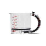 DREAMFARM messbecher measuring cup with clear markings, made of durable plastic, featuring a handle for easy pouring.