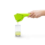 DREAMFARM orange juicer FLUICER with ergonomic handle and stainless steel basket for fresh citrus juice extraction.