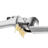 DREAMFARM garlic press GARJECT with stainless steel handle and chamber for effortless garlic crushing.
