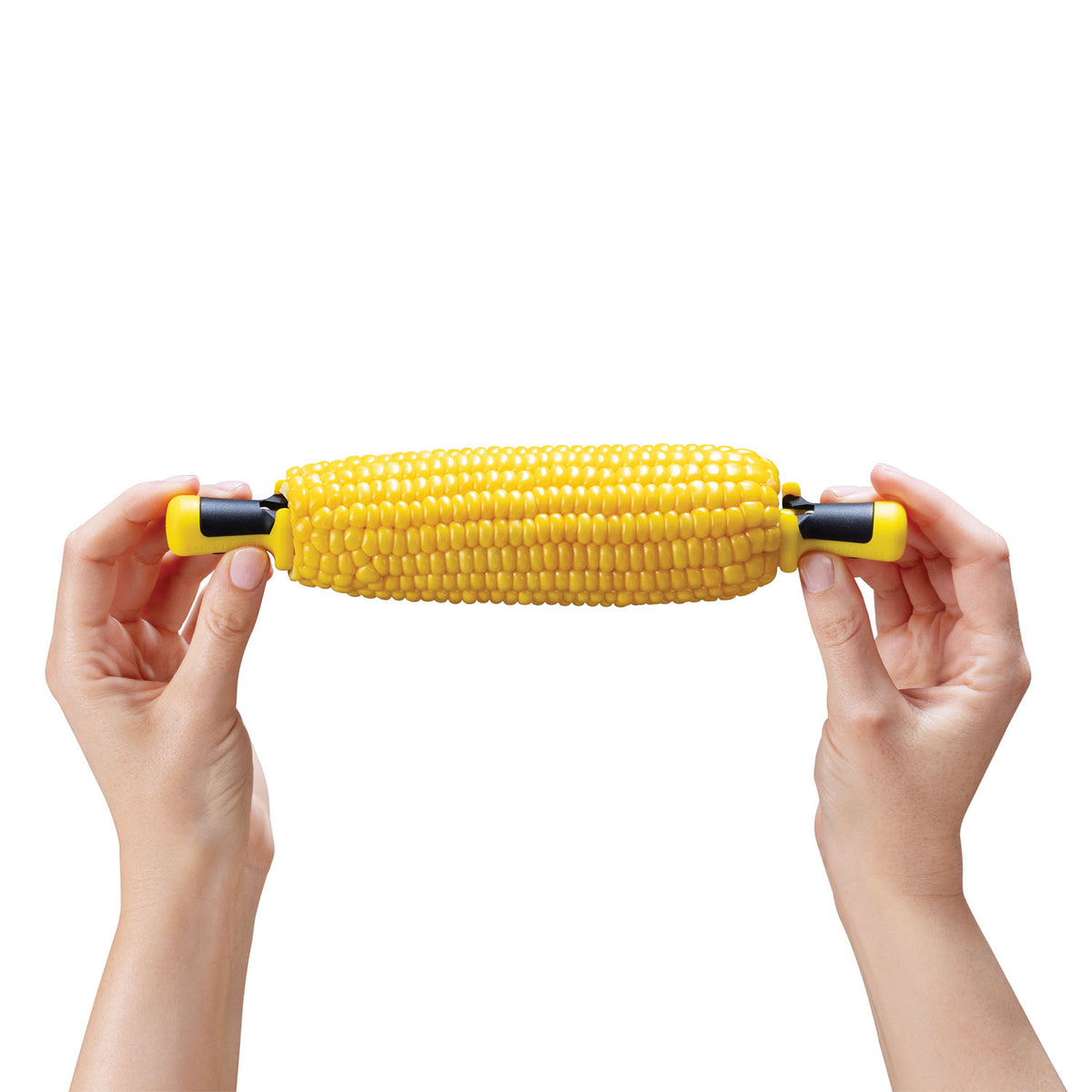 DREAMFARM yellow four-piece corn cob holder set with lock rings, designed for easy grilling and serving of corn on the cob.