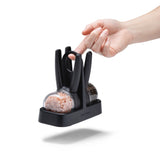 DREAMFARM ORTWO Lite black spice grinder set with two sleek, modern pepper and salt mills on a wooden surface.