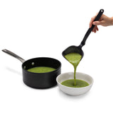 DREAMFARM red slotted ladle (Schöpfkelle) with a long handle, perfect for serving soups and stews in the kitchen.