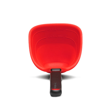 Red DREAMFARM Schöpfkelle ladle with a long handle, ideal for serving soups and stews in the kitchen.