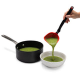 DREAMFARM red slotted ladle, kitchen scoop with long handle, used for serving soups or stews, made of durable material.